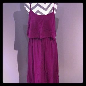 Knee length purple sleeveless dress.